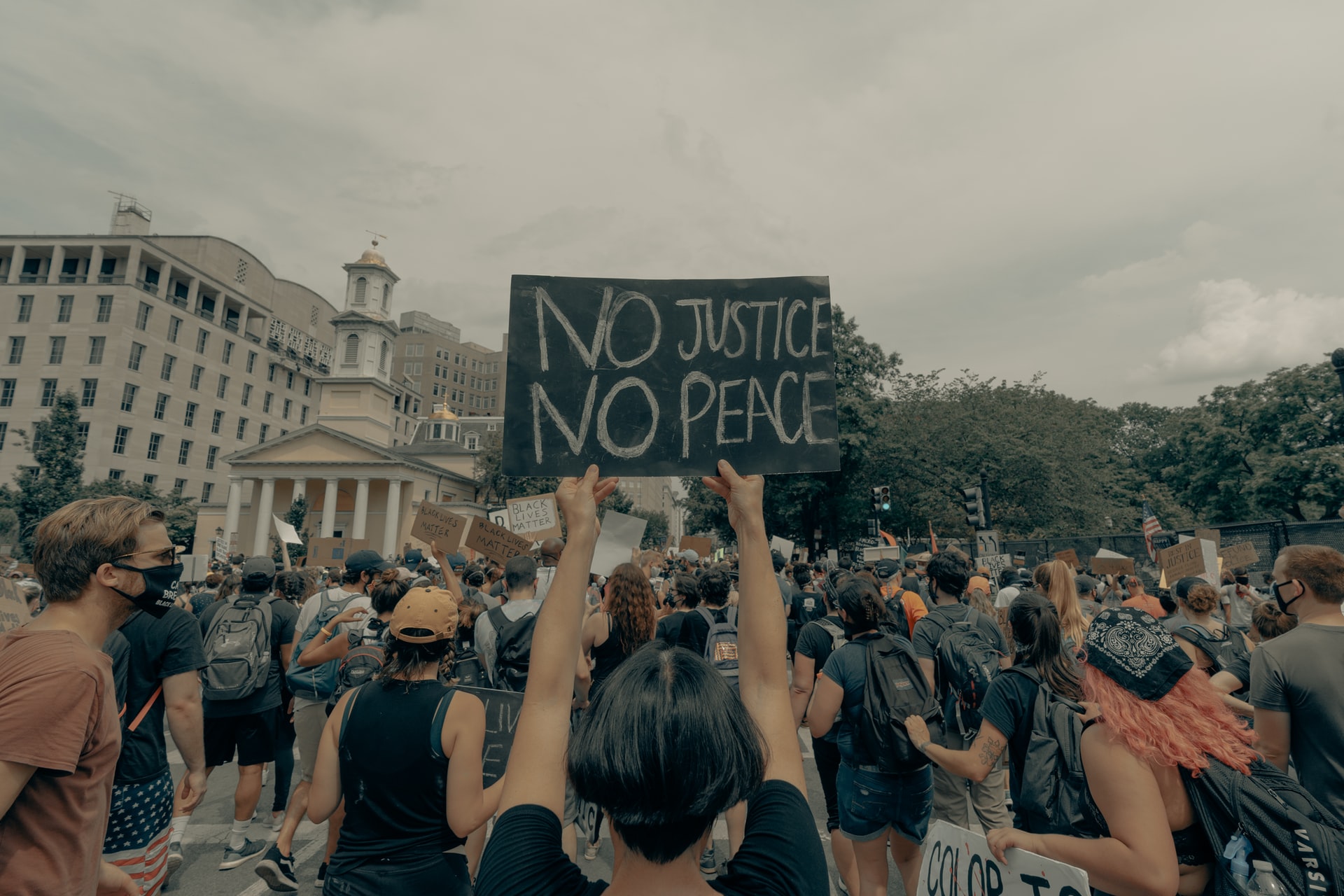 Woman holds up a "Black Lives Matter" sign